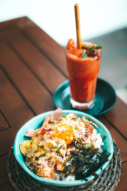 A Smoothie and a Bowl of Delicious Cooked Food