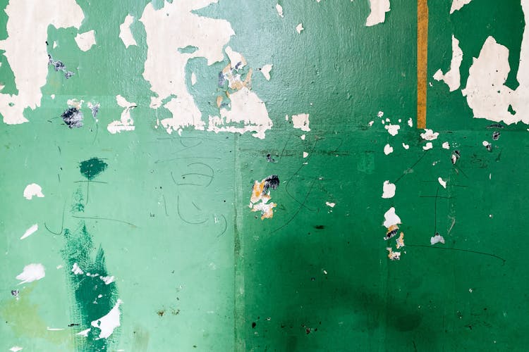 Green Paint Peeling From A Wall