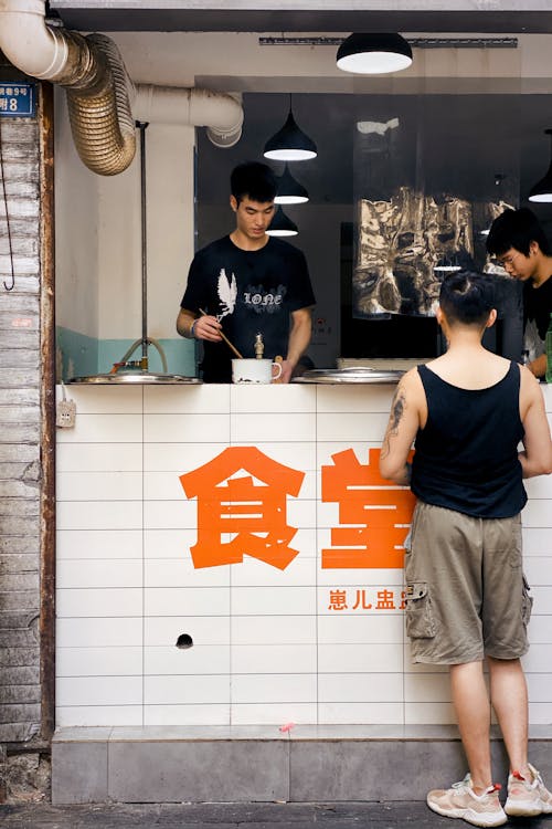 Free Person Ordering in a Japanese Street Food Restaurant  Stock Photo