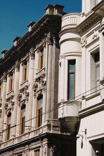 Detailed view of baroque and neoclassical building facades on a sunny day.