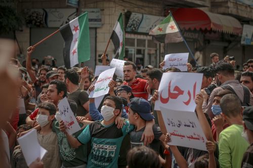 Free Crowd of people with placards and unofficial Syrian flags on picket in daylight Stock Photo