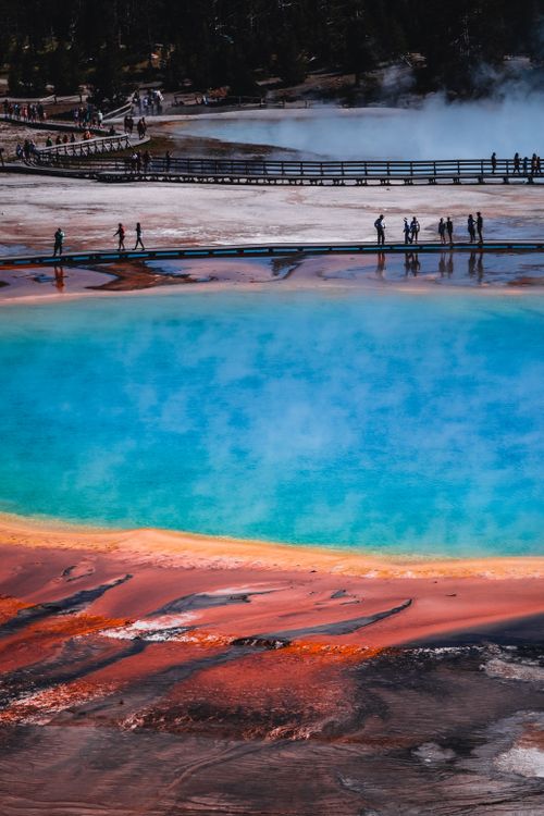 Free Aerial view capturing vibrant colors of Grand Prismatic Spring with tourists on boardwalk. Stock Photo