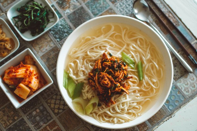 Bowl of Korean noodle soup with vegetables