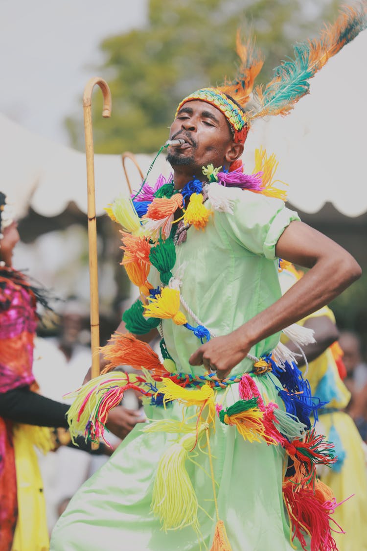 A Man Wearing Colorful Attire At The Festival