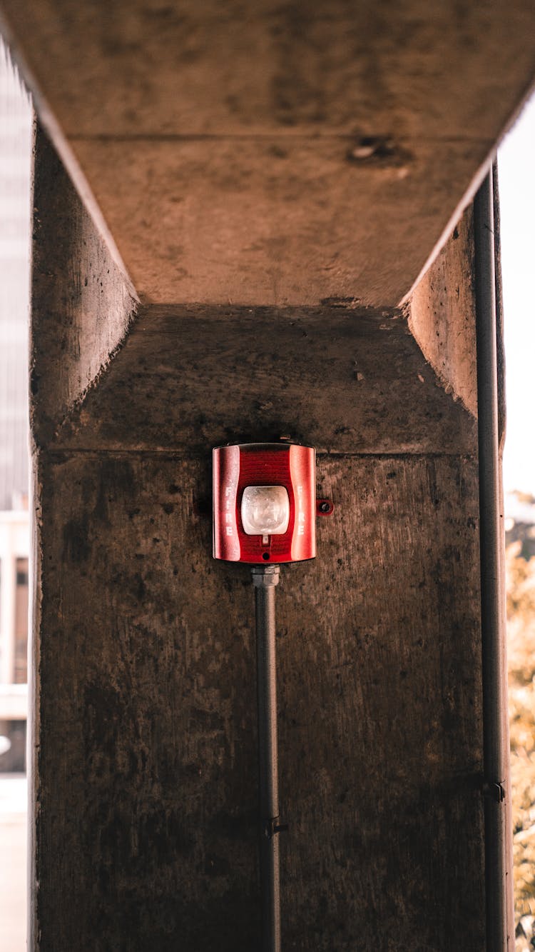 Red Fire Alarm Box On Stone Building