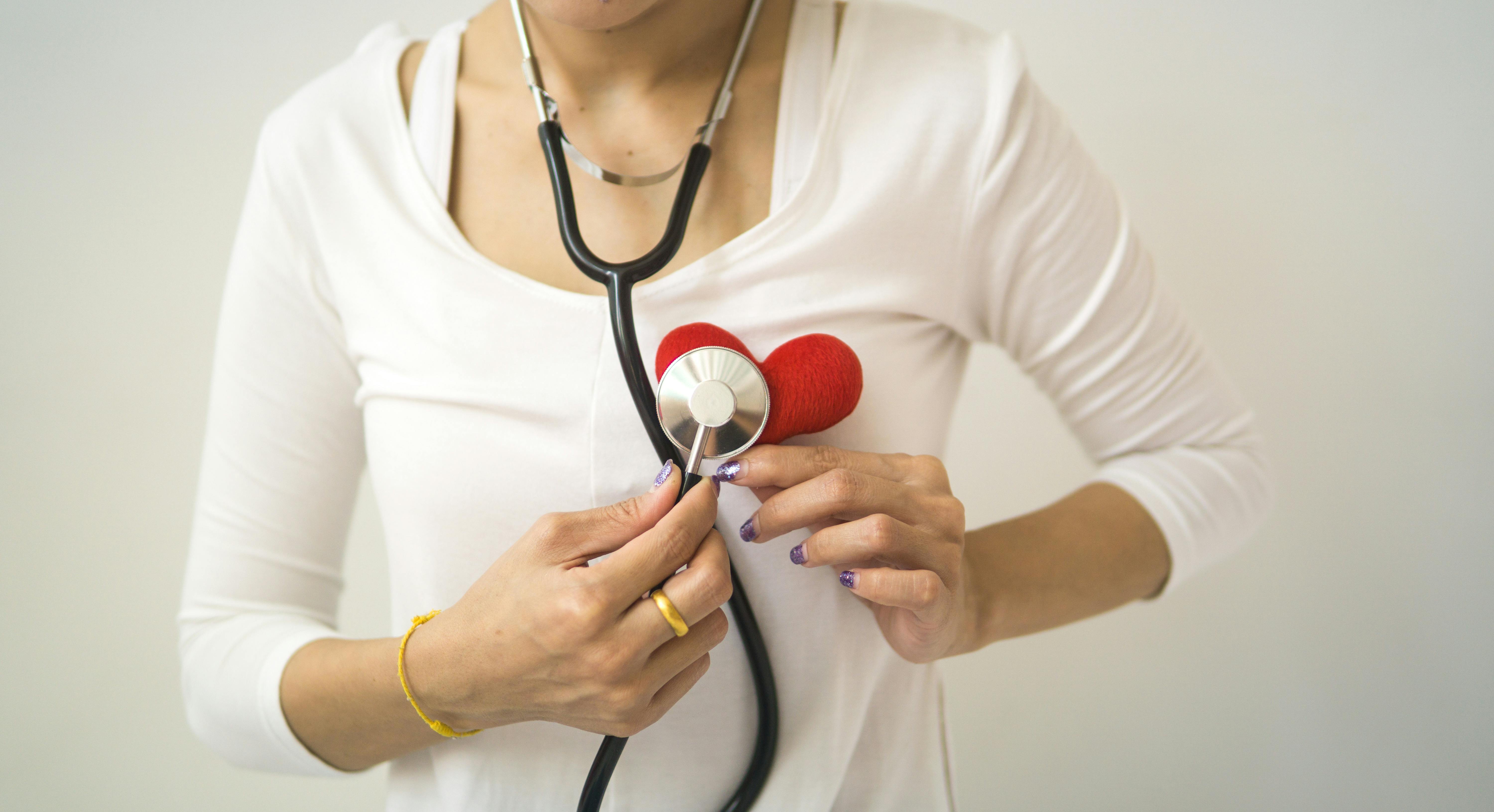 Doctor holding a heart, symbolizing the connection between love and health.