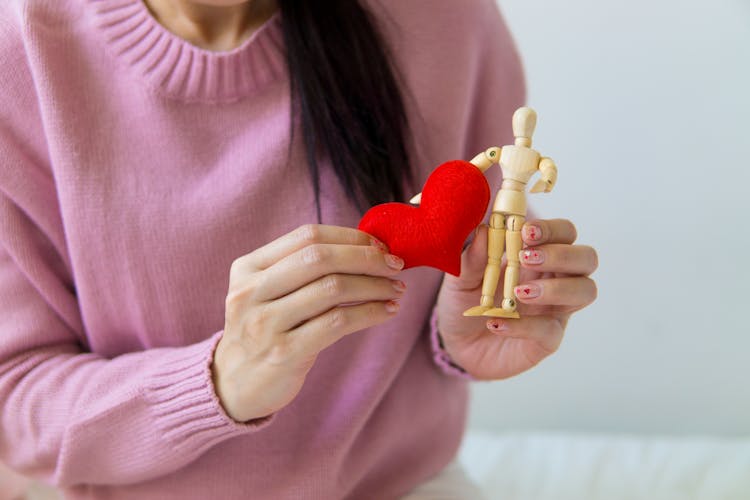 Crop Woman With Handmade Heart And Wooden Figure