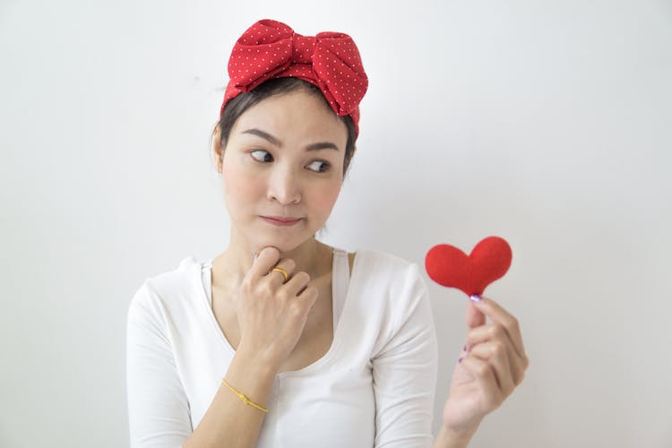 Pensive Woman Looking At Heart