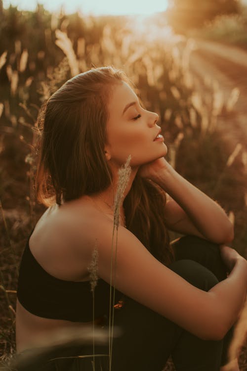 Young woman sitting in field