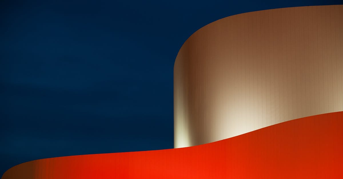 Abstract architectural image featuring bold colors and modern curves against a dark sky.