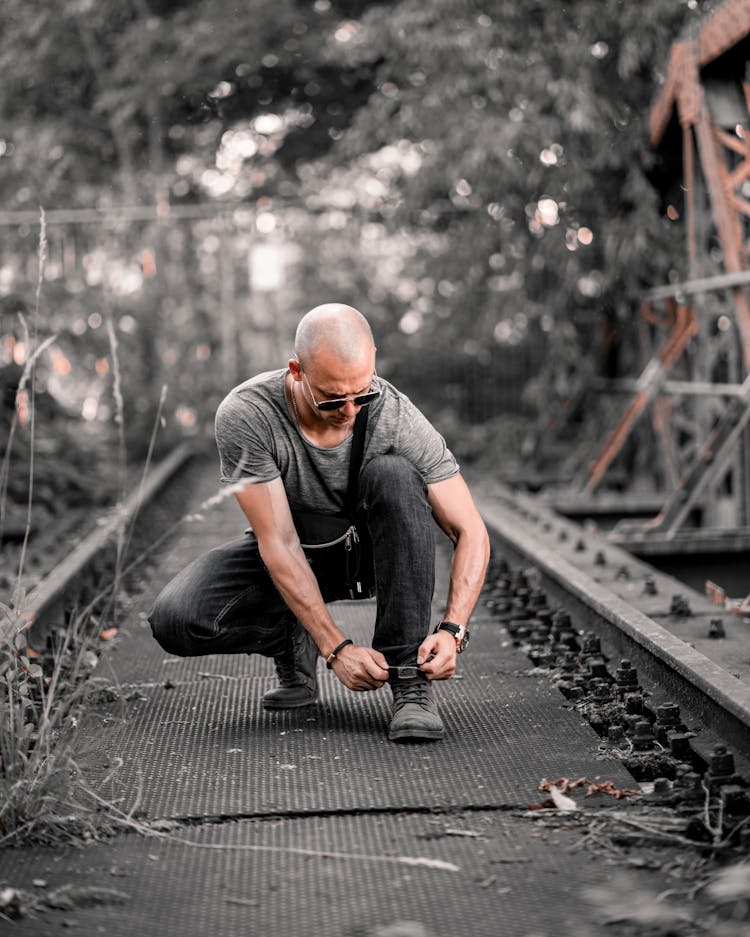 Bald Man Tying His Shoe Laces