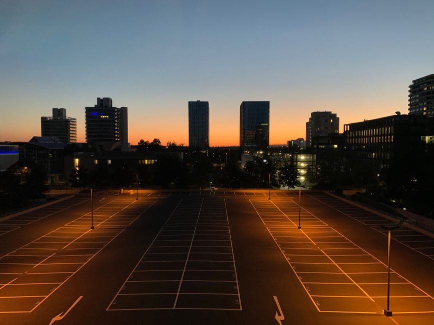 empty parking lot with security camera pole at dusk