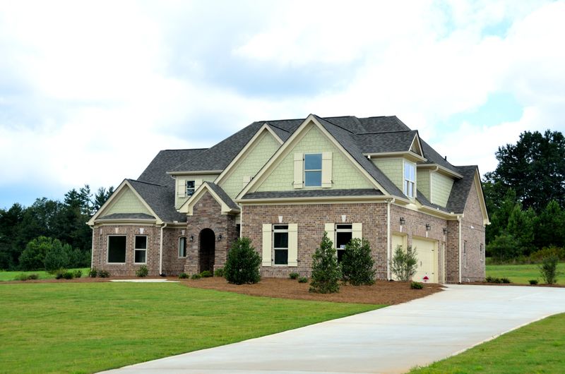 Brick family house with lawn and driveway