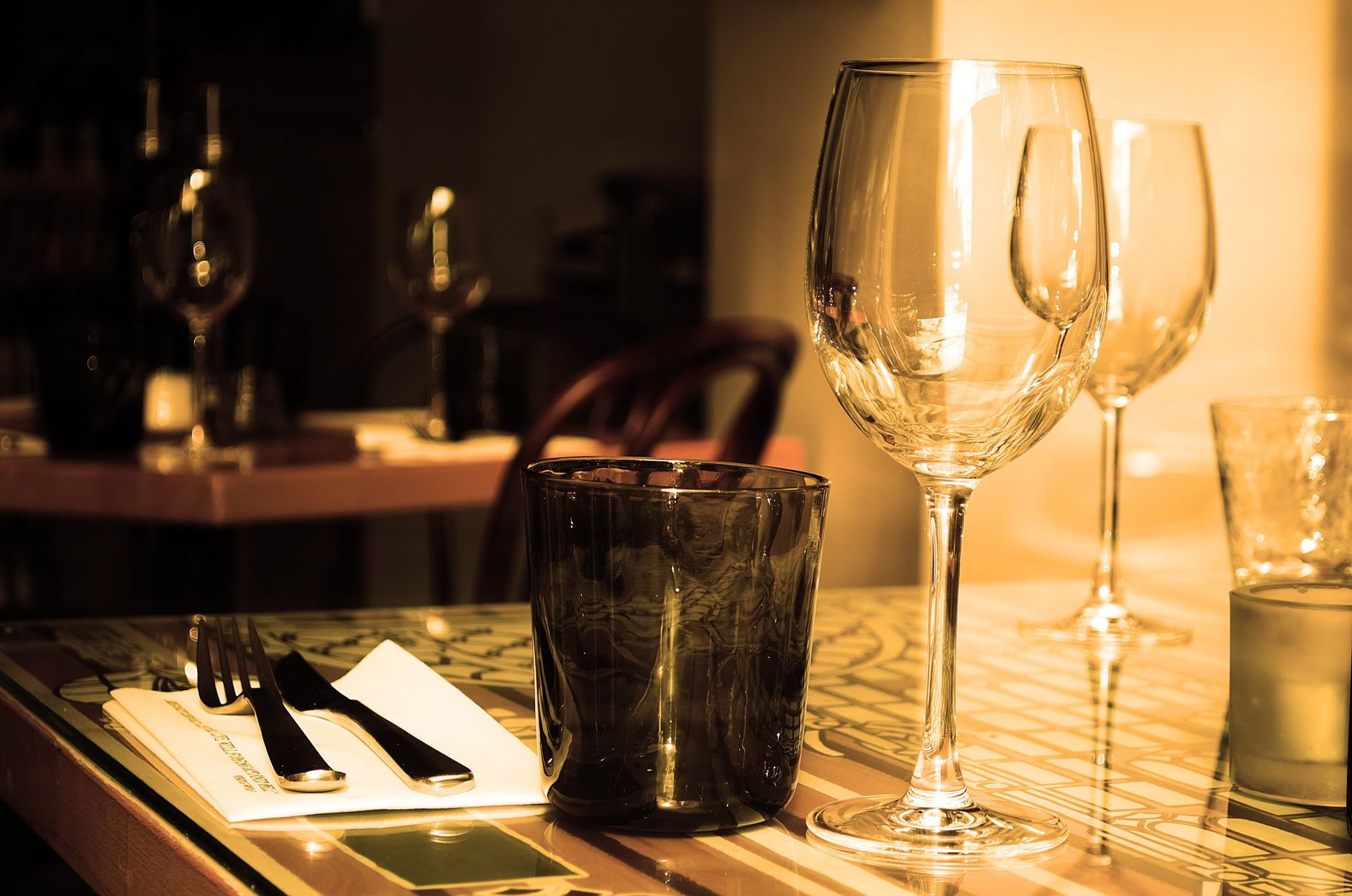Cozy interior of a traditional bistro restaurant with wooden tables and warm lighting