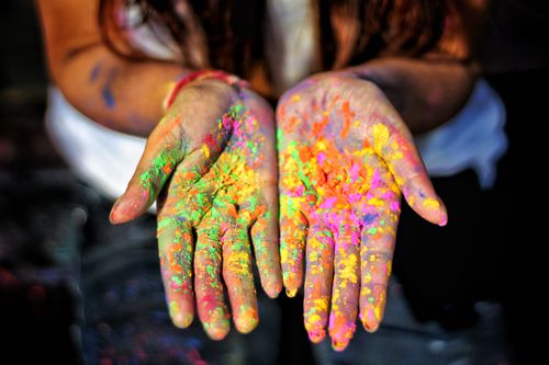 Free Close-up of colorful powdered hands during Holi festival, vibrant and joyful celebration. Stock Photo