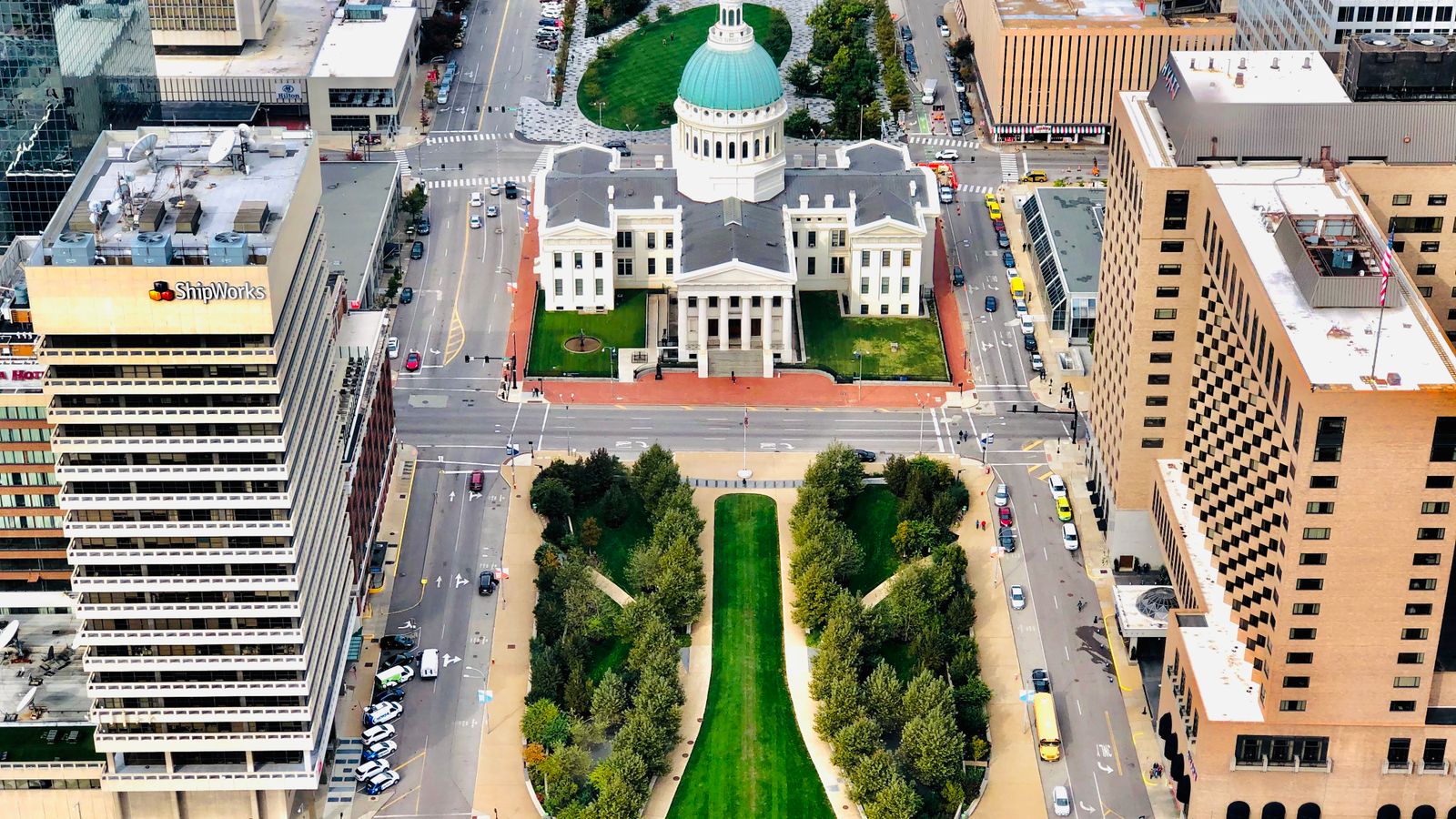 A stunning aerial view of the historic Old Courthouse in downtown St. Louis surrounded by city buildings.