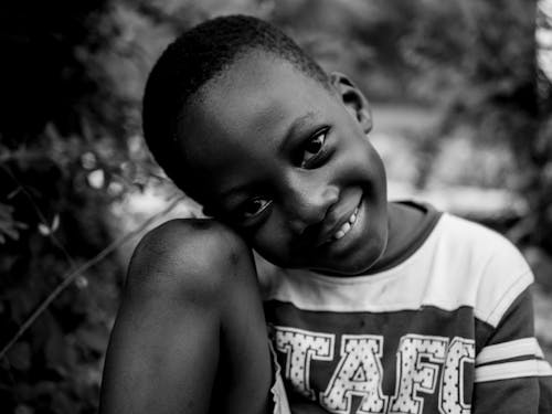 Grayscale Photo of Boy Smiling