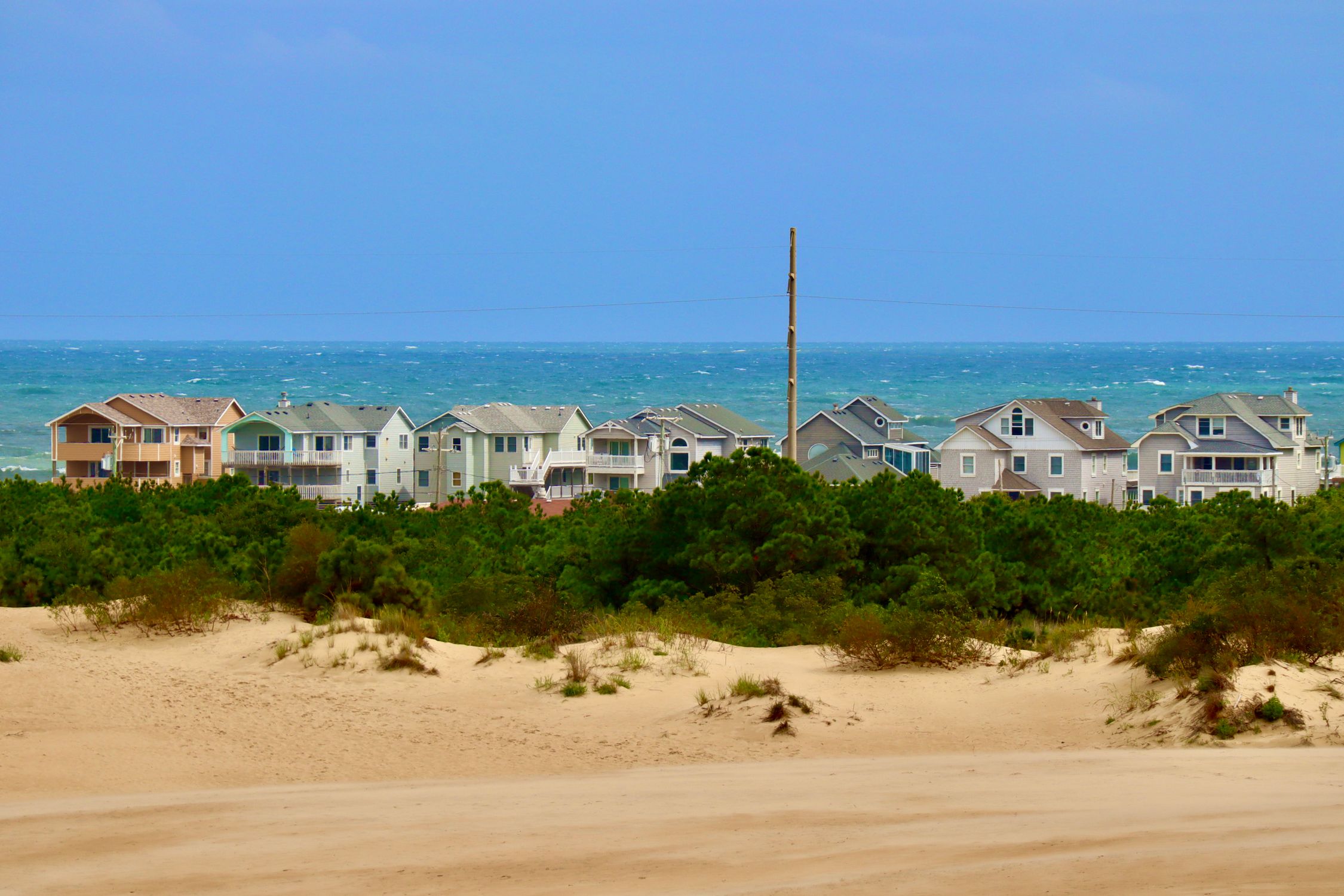 Charming beach houses overlooking sandy dunes and ocean in Nags Head, North Carolina.