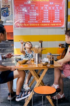 A family enjoying street food at an outdoor restaurant in Chengdu, China.