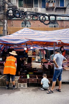 Vibrant street market scene with vendors and visitors in Wuhan Shi, China.