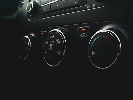 Detailed close-up of car dashboard controls featuring buttons, dials, and indicators.