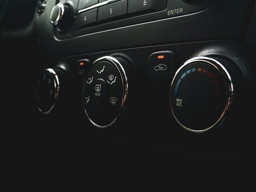 Detailed close-up of car dashboard controls featuring buttons, dials, and indicators.