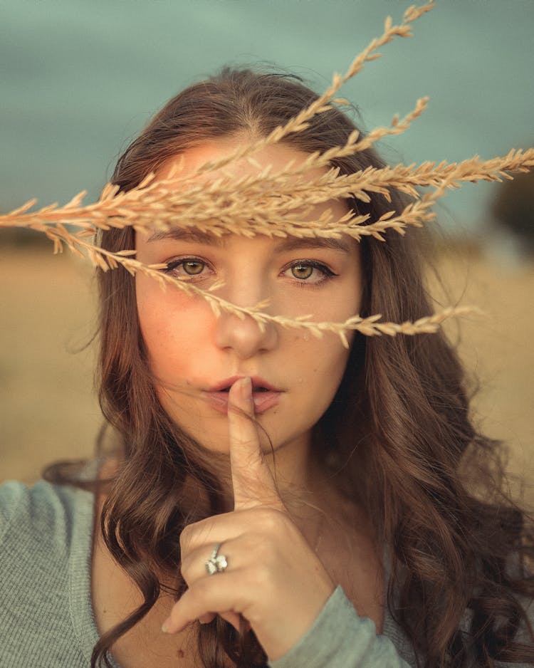 Woman With Finger On Mouth