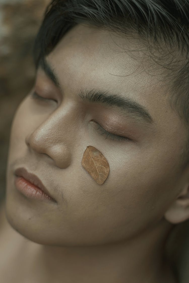 Young Man With Leaf On Face