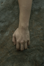 Male hand on grey stone