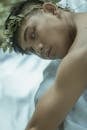 Ethnic tanned man with organic wreath