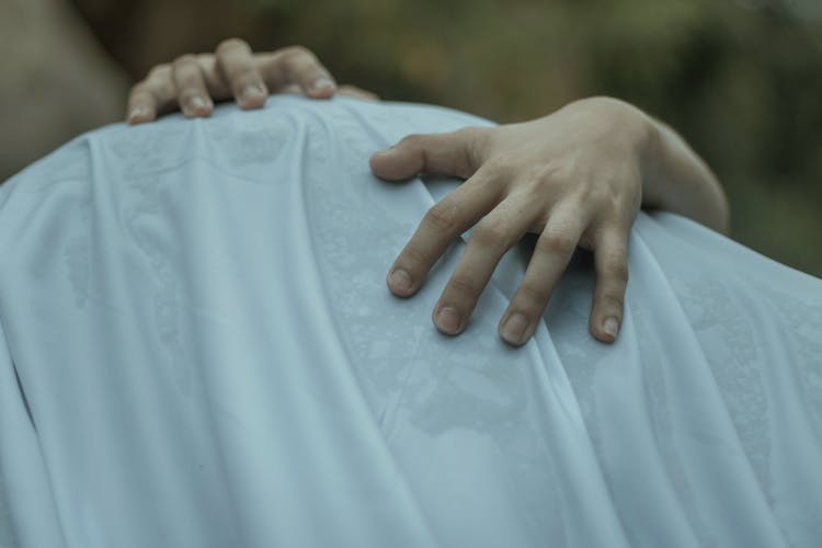 Person Climbing On Surface Covered With White Sheet