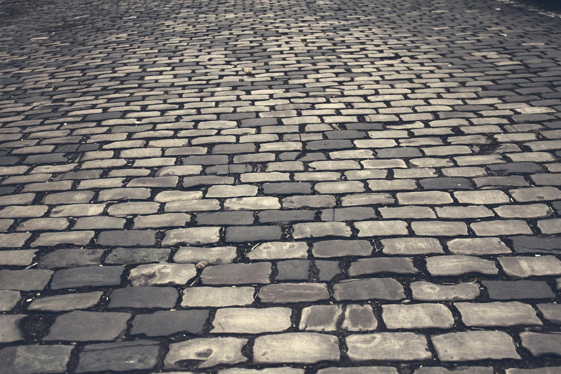 High-resolution image of a textured cobblestone pathway suitable for backgrounds or design projects.