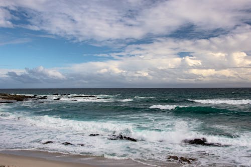 Photo of an Ocean Under White Clouds