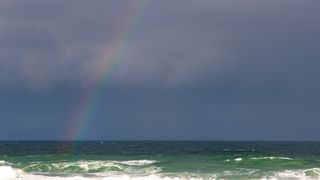 Rainbow over a breaking ocean swell, photo by Magda Ehlers on Pexels