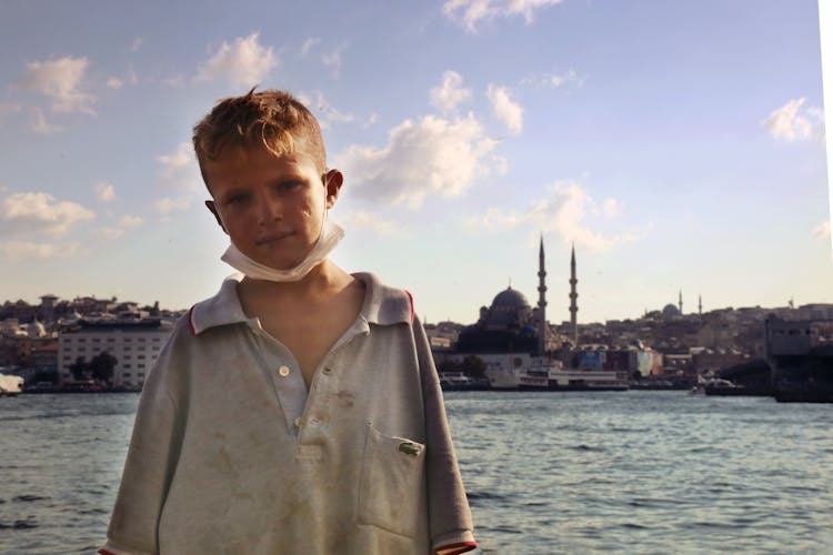 A Boy Wearing A Dirty Blue Shirt