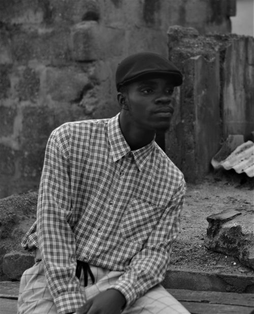 Free Black and white portrait of a man in a fashionable checkered shirt, wearing a cap. Stock Photo