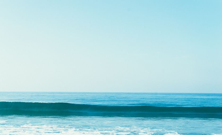 Tranquil ocean scene with gentle waves and a clear blue sky. Perfect for nature backgrounds.