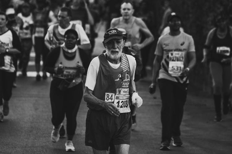 Black And White Photo Of An Elderly Man Running