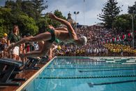 Man in Blue Shorts Jumping on Pool