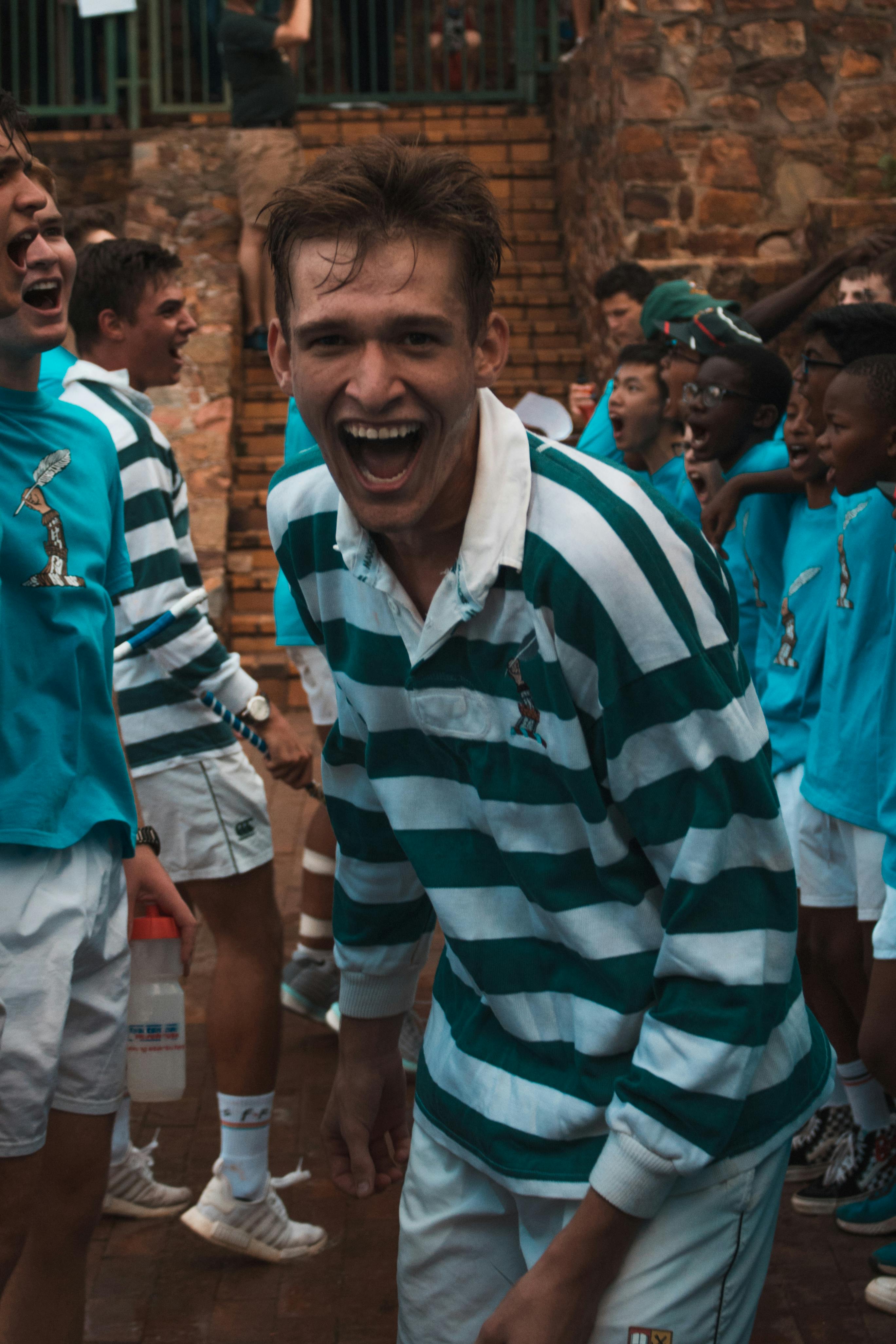 Man in Green and White Striped Polo Shirt Smiling · Free Stock Photo