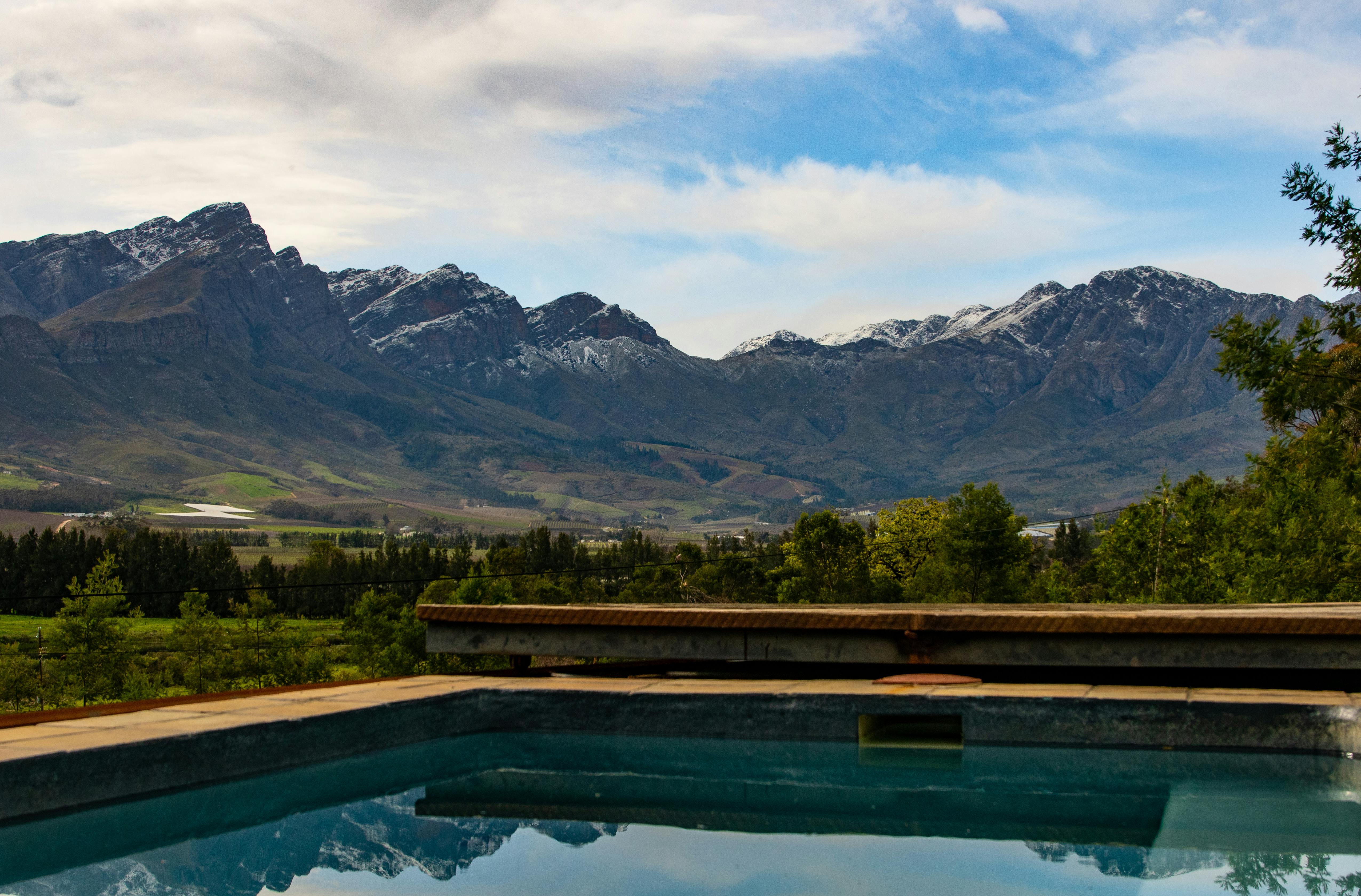 Capture the serene beauty of a mountain view and pool reflection in Tulbagh, South Africa.