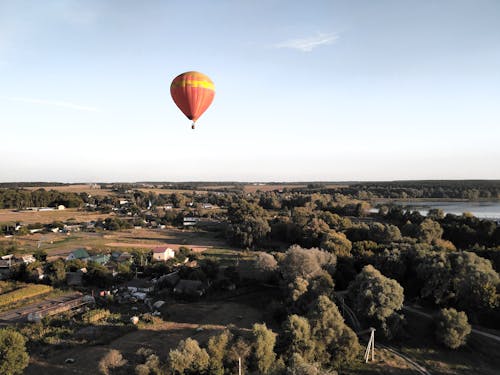 A Hot Air Balloon Flying over a Rural Area