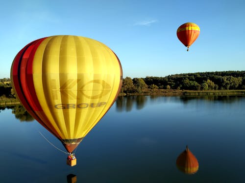 Hot Air Balloons Flying over the Lake