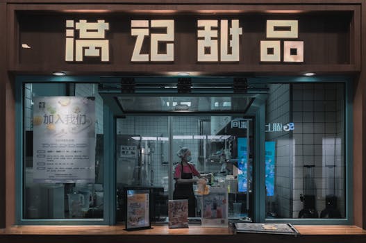 A Japanese sweet shop with a staff member working inside, seen through the window.