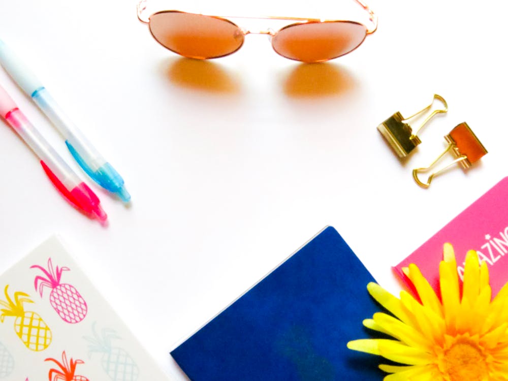 Free Brown Sunglasses Beside Click Pens Stock Photo