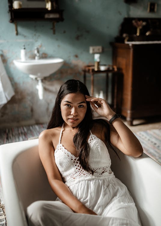 Free Woman Sitting in Empty Bathtub Stock Photo