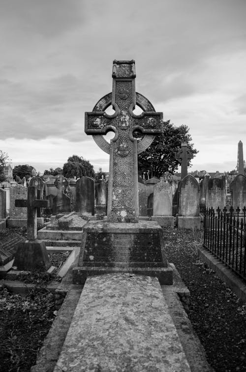 Grayscale Photography of Cemetery with Celtic Cross