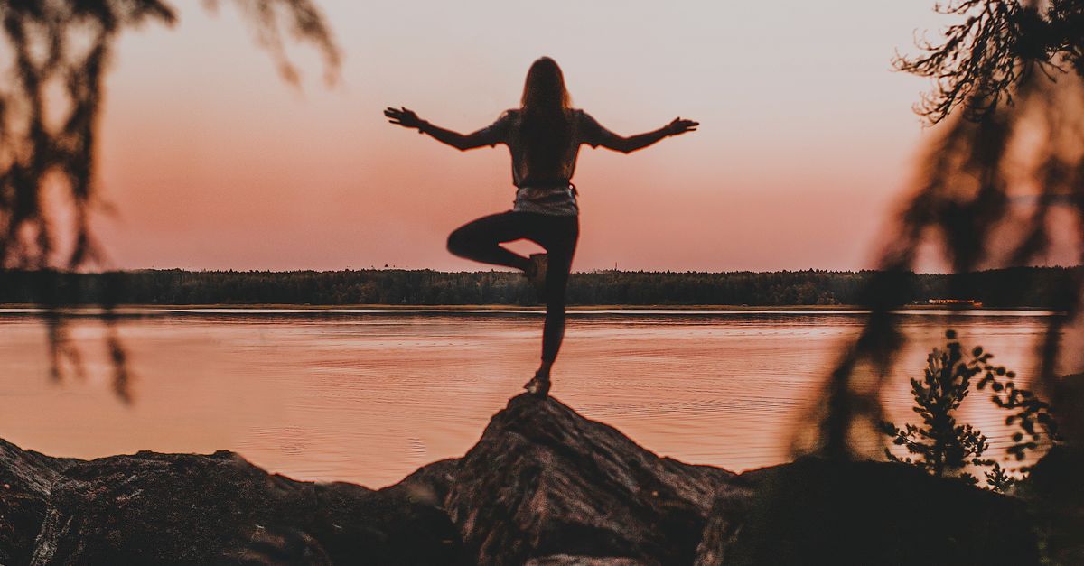 A Person Standing on the Rock Doing Yoga · Free Stock Photo