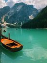Brown Wooden Boat on Green Lake Near Mountain