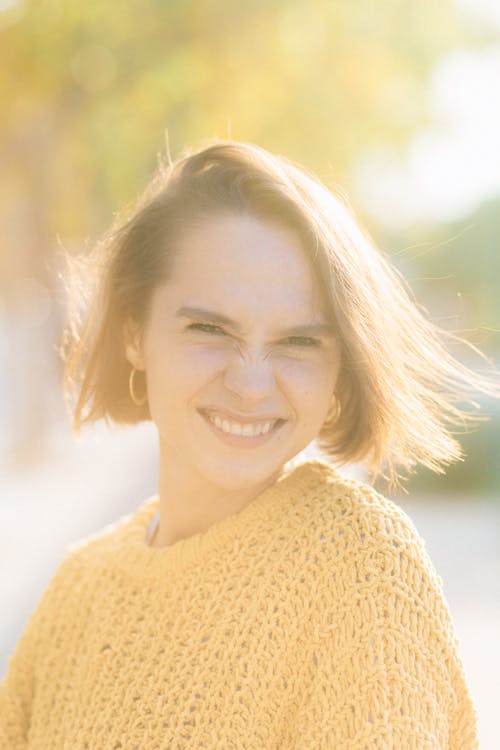  of a



Smiling Woman in Yellow Knitted Sweater